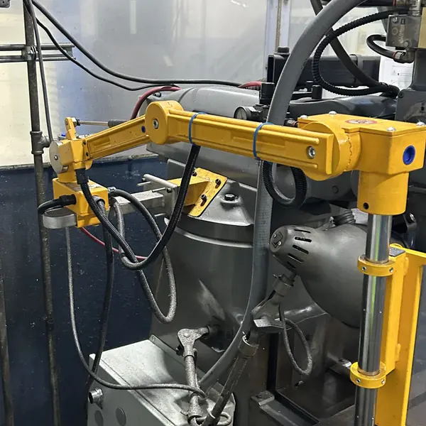 Yellow articulating guard arm mounted on the side of a Bridgeport mill
