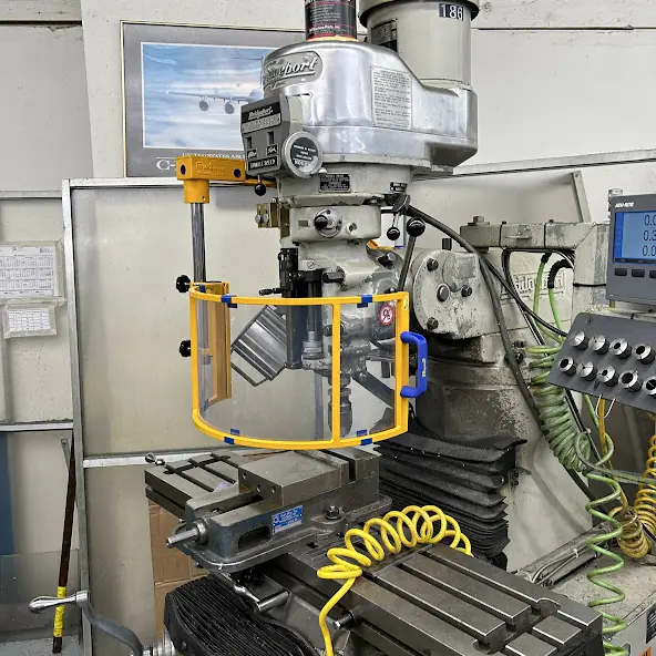 Bridgeport mill with a yellow spindle shield and power drawbar