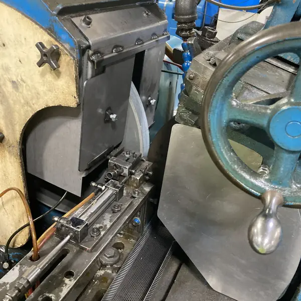 Steel guard at the work rest of a Cincinnati centerless grinder