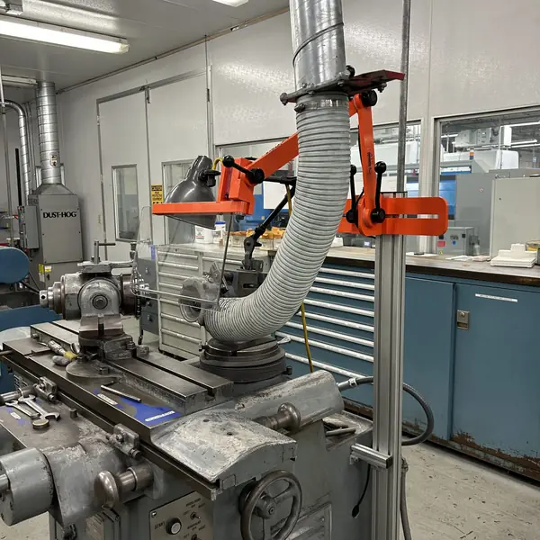 Cincinnati tool and cutter grinder with an orange articulating guard and dust hose