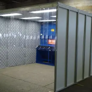 Enclosure with clear strip curtains and quilted panels around a downdraft workstation