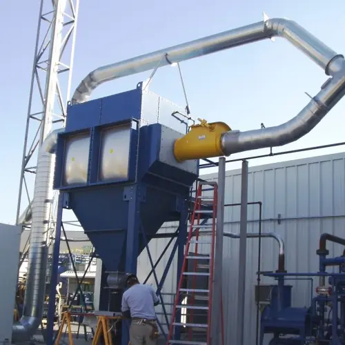 Blue dust collector with galvanized ductwork being installed outside a plant