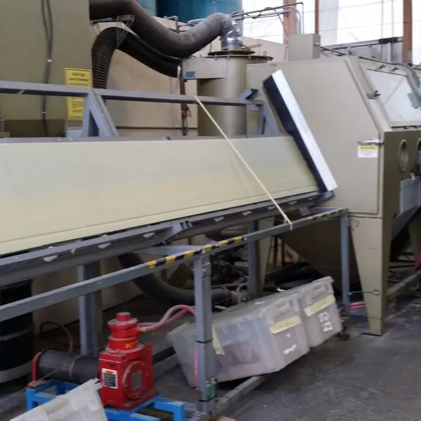 Long grit blasting cabinet built for Apache helicopter rotor blades