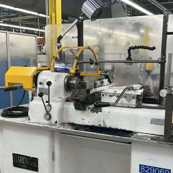 Hardinge Hot Rod lathe with a yellow headstock cover and chuck shield