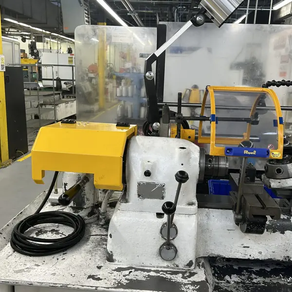 Hardinge Hot Rod lathe with a yellow headstock guard and round chuck shield