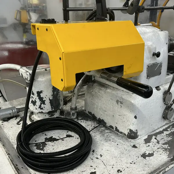 Close-up of a yellow headstock guard on a Hardinge Hot Rod lathe