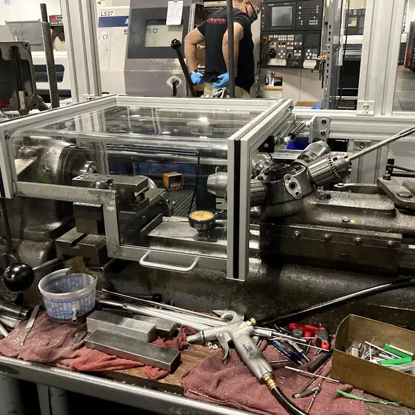 Clear aluminum-frame guard enclosure over the spindle of a Hardinge lathe
