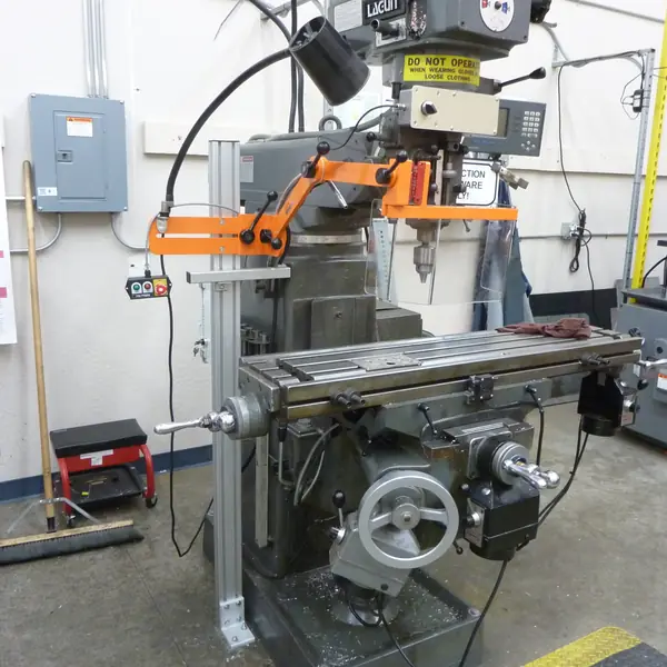 Lagun milling machine with an orange articulating spindle guard