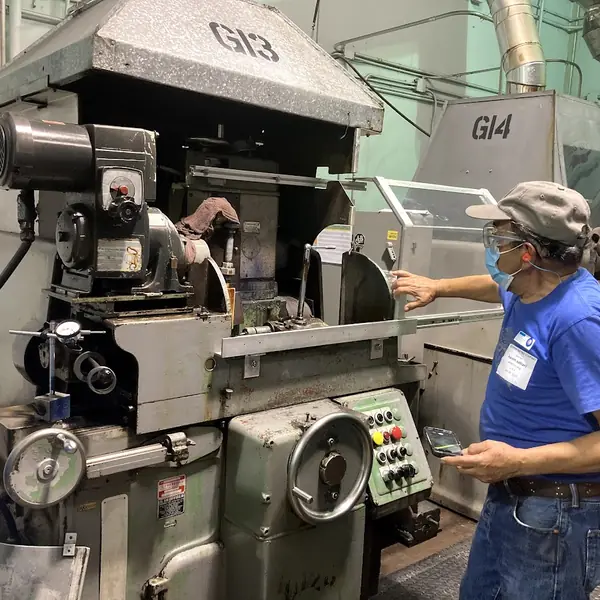 Operator at an LCF grinder fitted with a guard enclosure