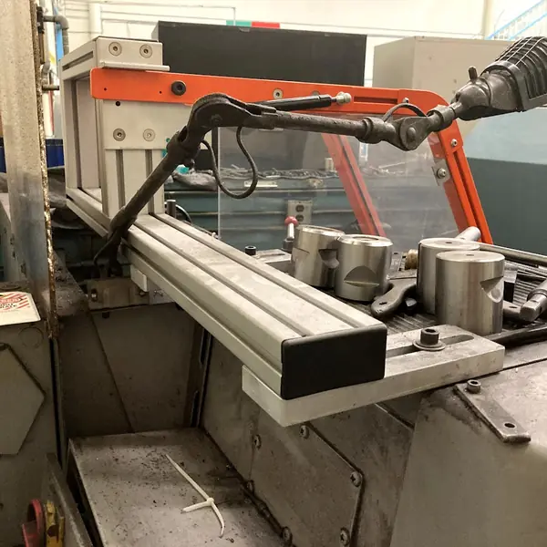 Mori Seiki lathe with an orange-frame guard on an aluminum swing arm