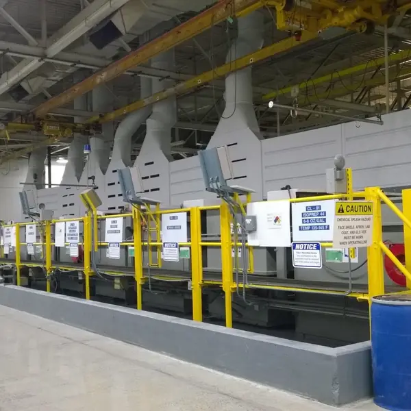 Long plating line with exhaust hoods, yellow safety rails and stairs