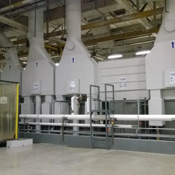 Process tank line with white exhaust hoods, PVC piping and a clear strip-curtain enclosure