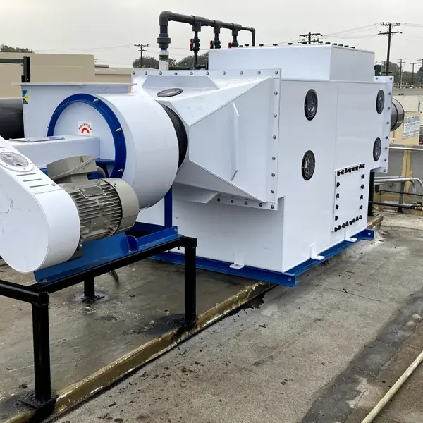 Rooftop fume scrubber with a white exhaust blower and PVC piping