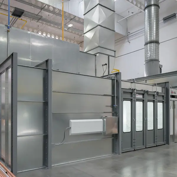 Large grey sanding booth with glass doors and overhead exhaust ducting