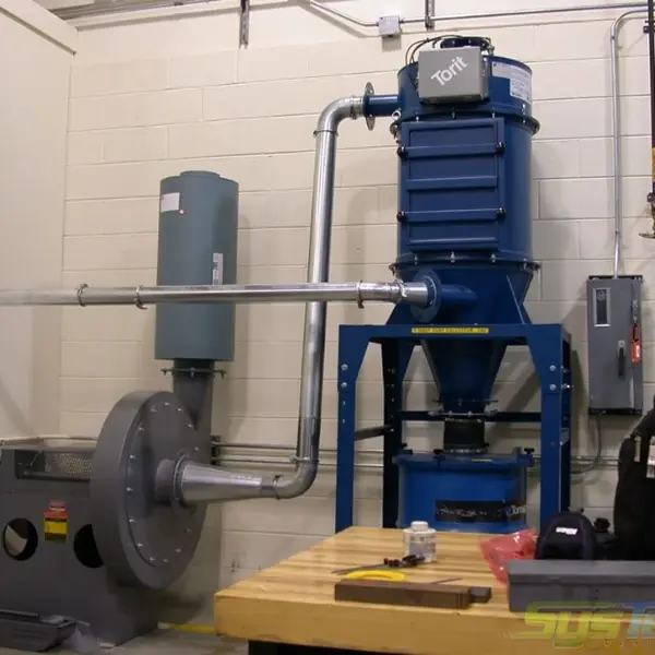 Blue Torit dust collector and blower piped to a workbench